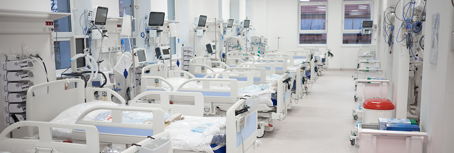 A hospital ward lined with beds and equipment